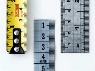 Measuring tape and ruler implying metrics measurement.