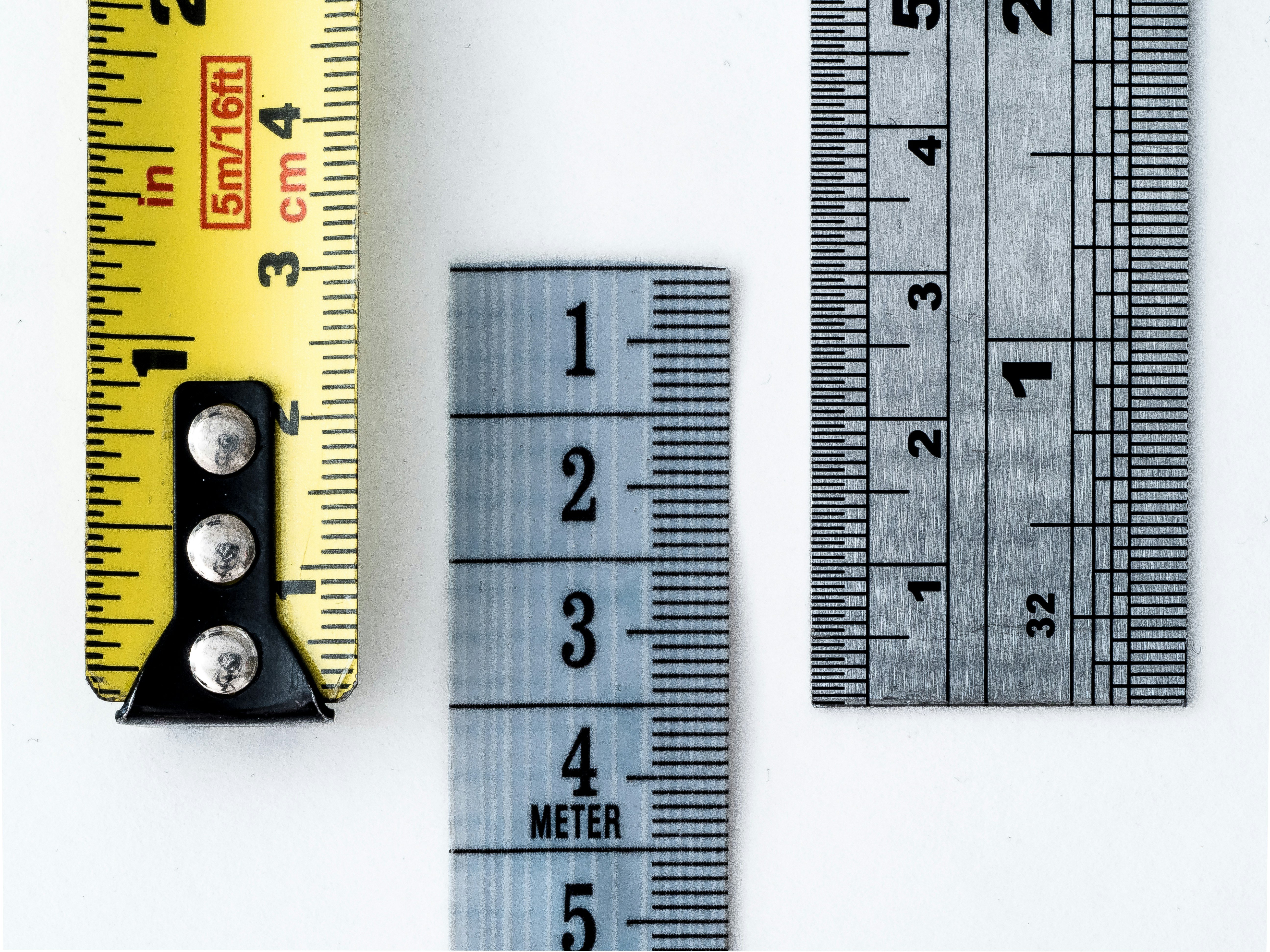 Measuring tape and ruler implying metrics measurement.